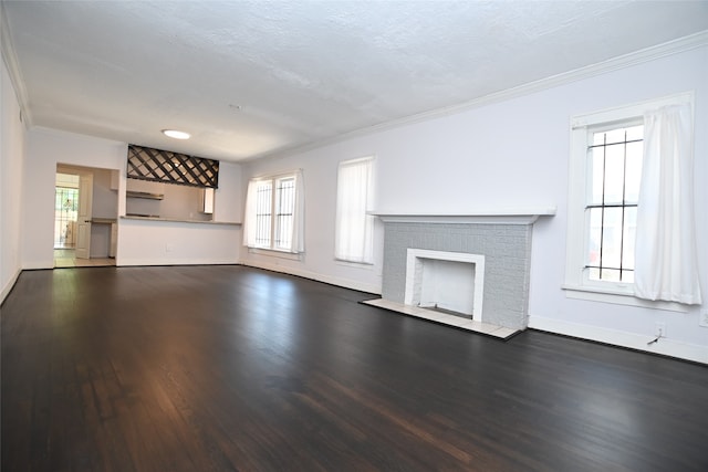 unfurnished living room featuring a fireplace, dark hardwood / wood-style floors, a wealth of natural light, and a textured ceiling