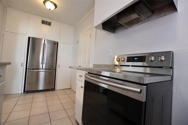 1929 W Dallas St, Houston, TX 77019 - kitchen featuring appliances with stainless steel finishes, ventilation hood, crown molding, white cabinetry, and light tile patterned flooring