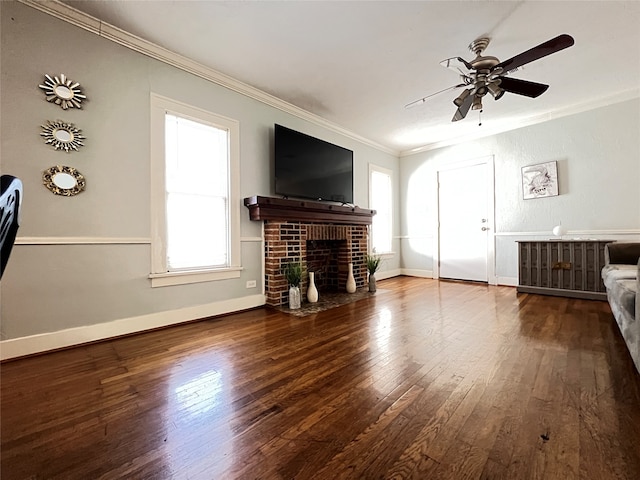 unfurnished living room with crown molding, hardwood / wood-style flooring, a brick fireplace, and ceiling fan