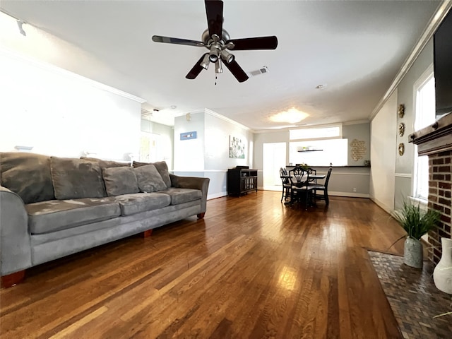 living room featuring ceiling fan, hardwood / wood-style flooring, and crown molding