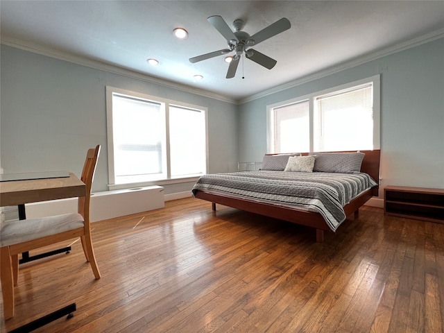 bedroom featuring ceiling fan, crown molding, and hardwood / wood-style flooring