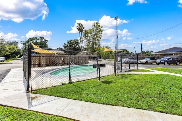 view of pool with a yard