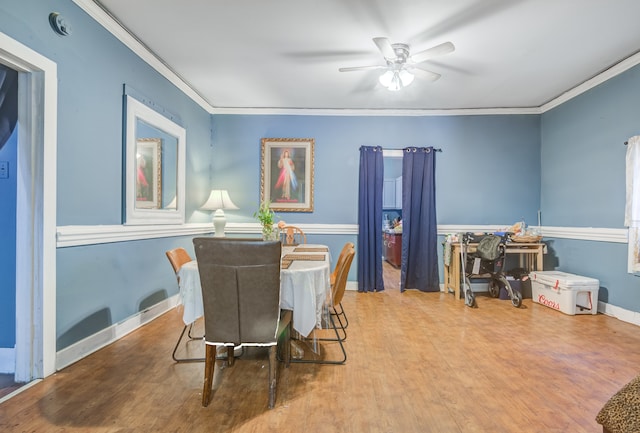 dining space featuring ceiling fan, hardwood / wood-style floors, and crown molding