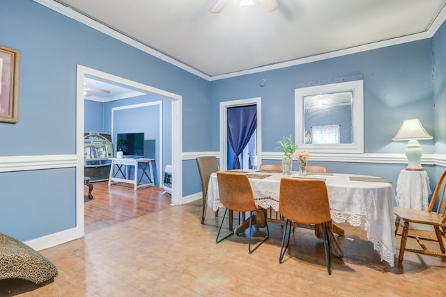 dining space featuring hardwood / wood-style flooring, ornamental molding, and ceiling fan