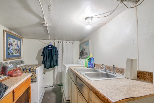 interior space featuring sink, washer and dryer, and concrete flooring