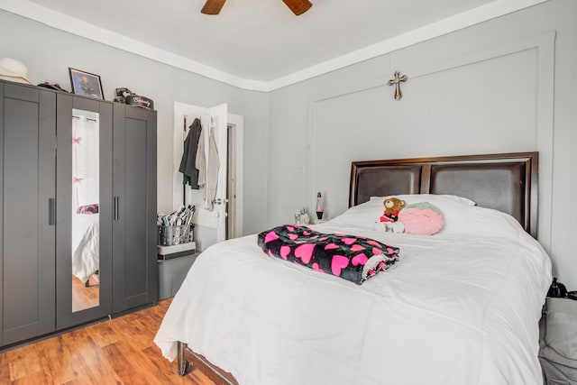 bedroom with ceiling fan and light hardwood / wood-style floors