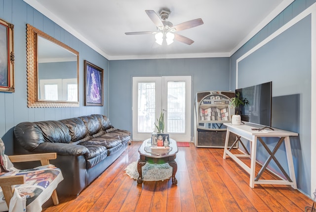 living room featuring hardwood / wood-style flooring, french doors, ornamental molding, and ceiling fan