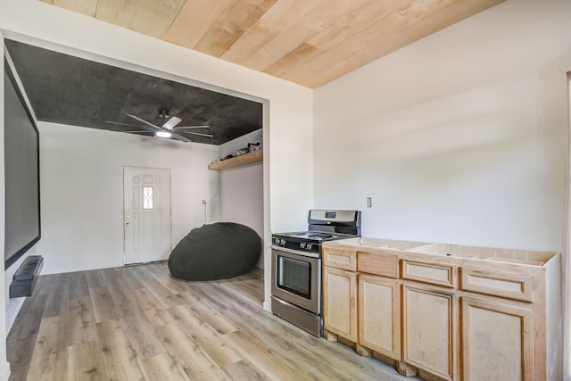 kitchen featuring stainless steel electric range oven, light wood-type flooring, ceiling fan, and light brown cabinets