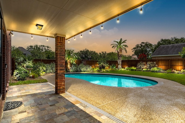 view of swimming pool with a fenced in pool, a fenced backyard, and a patio