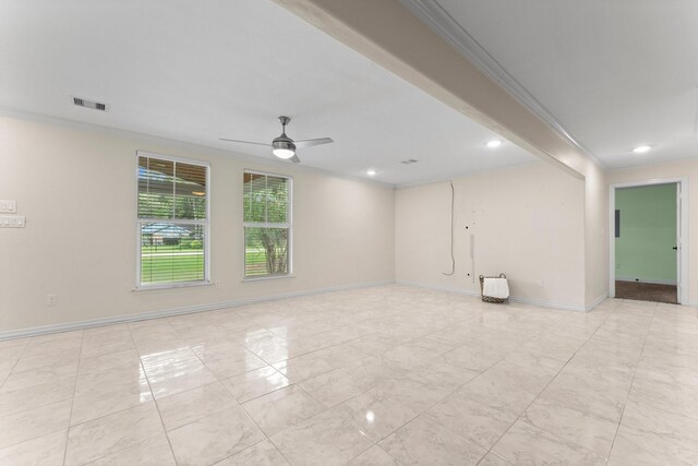 spare room featuring ceiling fan and ornamental molding