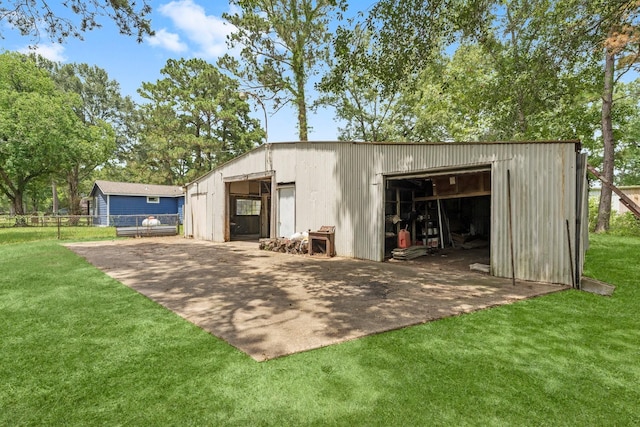 view of pole building featuring a yard and fence