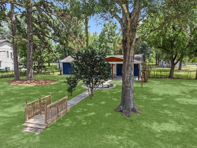 view of yard featuring fence and an outdoor structure