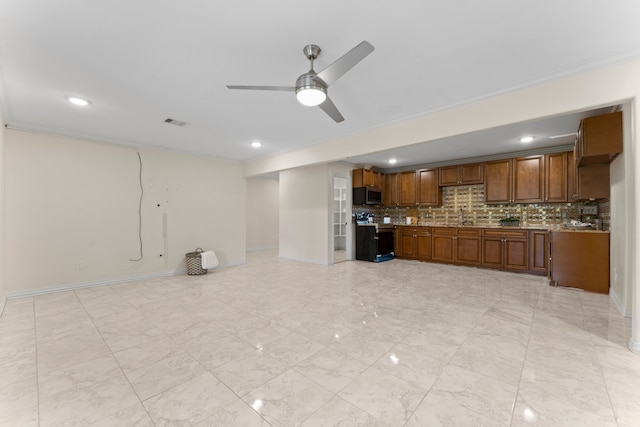 kitchen with electric stove, backsplash, crown molding, ceiling fan, and sink