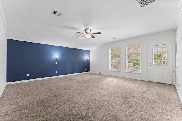 empty room with a ceiling fan, carpet, a healthy amount of sunlight, and visible vents