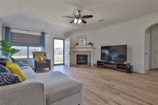 living room with ceiling fan, wood-type flooring, and ornamental molding