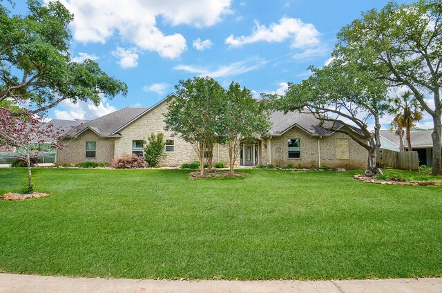 ranch-style home with a front lawn