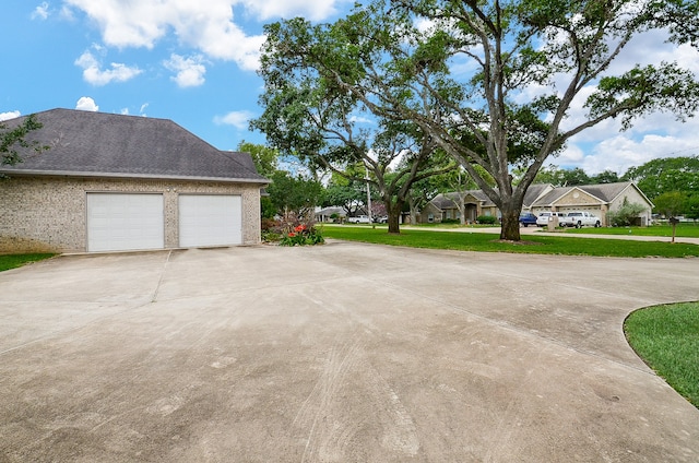 view of property exterior with a garage and a yard