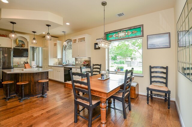 dining area with dark hardwood / wood-style floors and sink