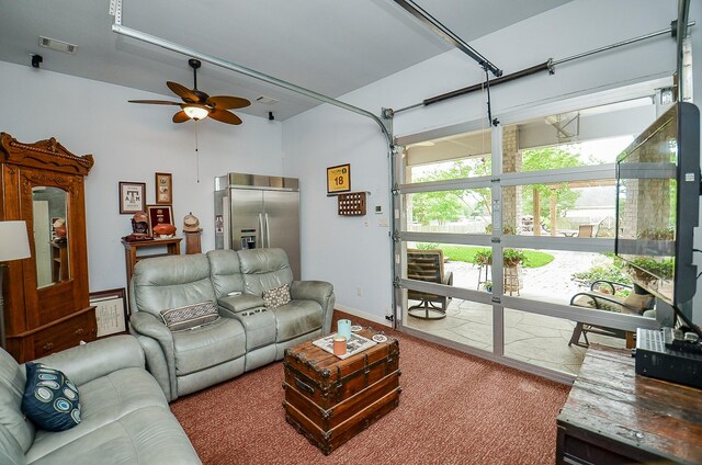 living room with ceiling fan and carpet