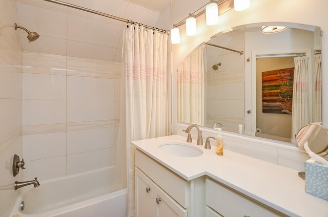 bathroom featuring shower / bathtub combination with curtain and vanity