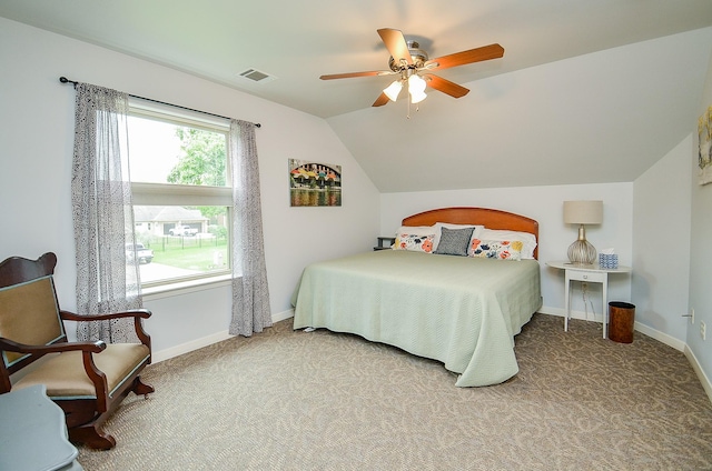 bedroom with visible vents, baseboards, lofted ceiling, and carpet