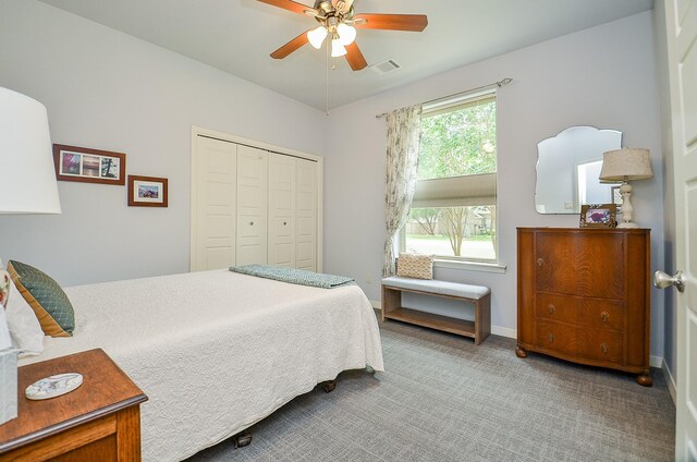 carpeted bedroom with a closet and ceiling fan