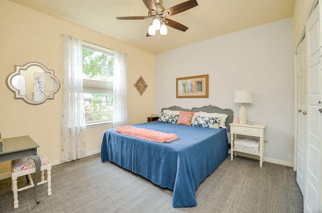 carpeted bedroom featuring a ceiling fan and baseboards