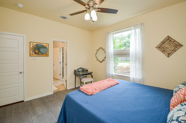 carpeted bedroom with a ceiling fan, baseboards, and visible vents