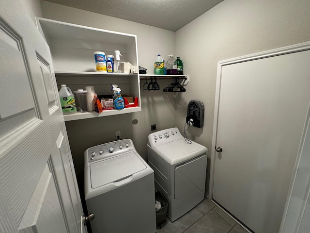 clothes washing area with a textured ceiling, tile patterned flooring, and independent washer and dryer