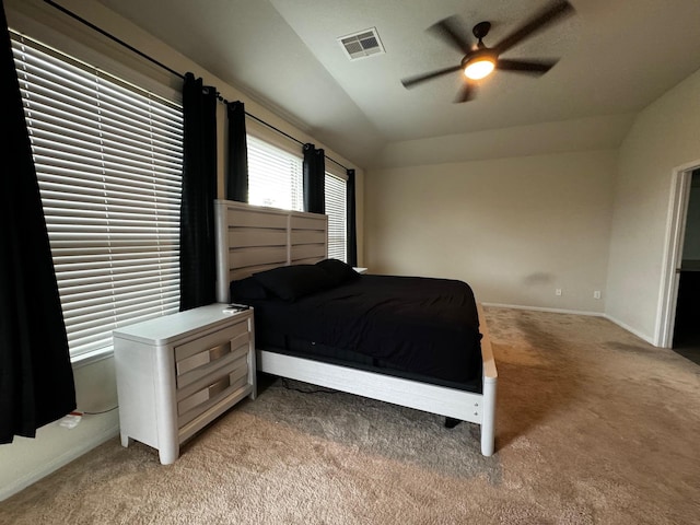 carpeted bedroom with ceiling fan and vaulted ceiling