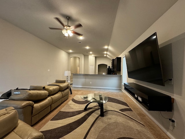 carpeted living room featuring lofted ceiling and ceiling fan