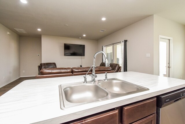 kitchen with dishwasher, dark brown cabinetry, dark hardwood / wood-style floors, and sink