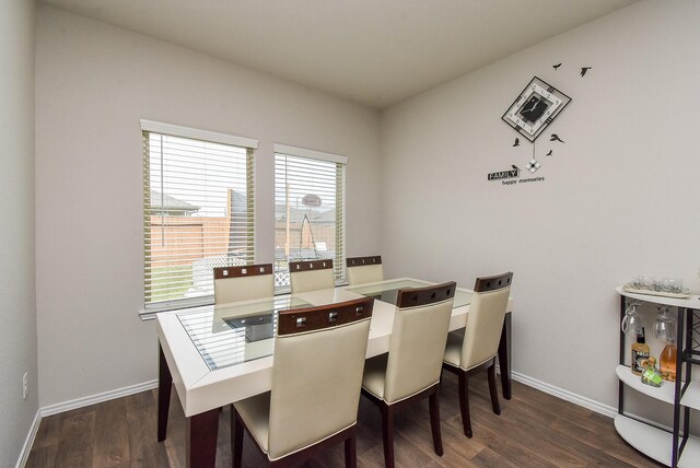 dining space with dark hardwood / wood-style floors