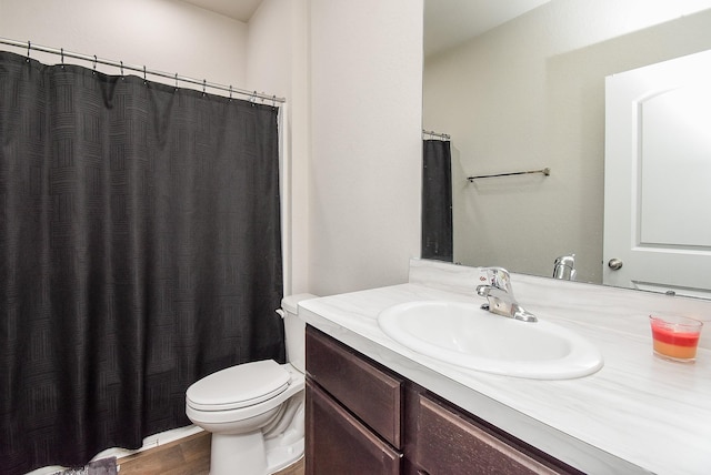 bathroom with a shower with shower curtain, vanity, wood-type flooring, and toilet