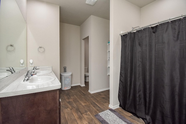 bathroom featuring hardwood / wood-style floors, vanity, and toilet