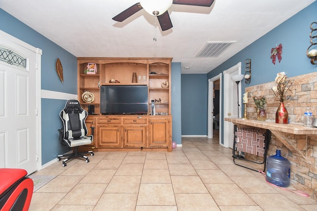 tiled living room with ceiling fan