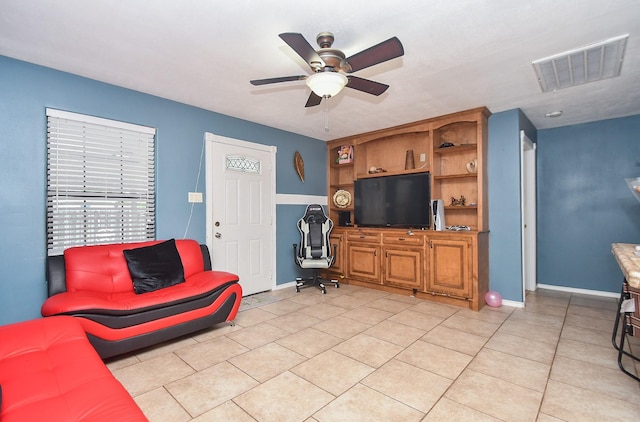 tiled living room with ceiling fan