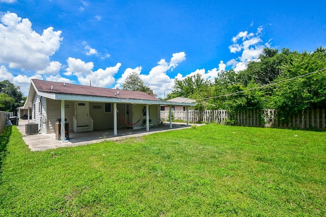 back of property featuring a lawn, a patio, and central AC unit