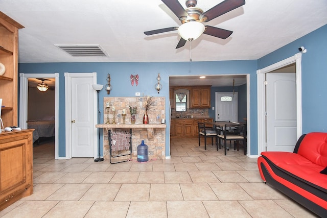 kitchen featuring decorative backsplash, light tile patterned floors, and ceiling fan