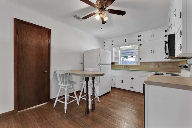 kitchen with range, white refrigerator, backsplash, dark hardwood / wood-style floors, and white cabinetry