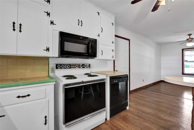 kitchen featuring white cabinetry, ceiling fan, black appliances, hardwood / wood-style floors, and decorative backsplash