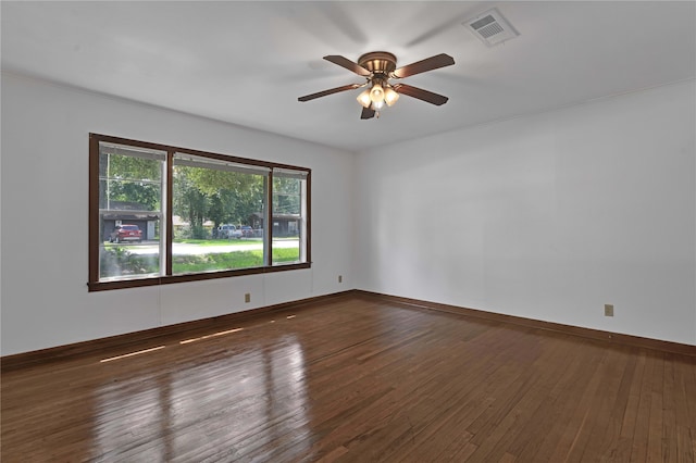 spare room featuring dark hardwood / wood-style flooring and ceiling fan