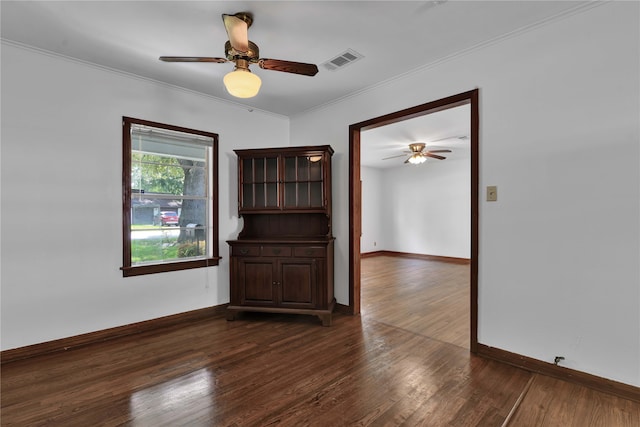 unfurnished room with ceiling fan, dark hardwood / wood-style floors, and crown molding