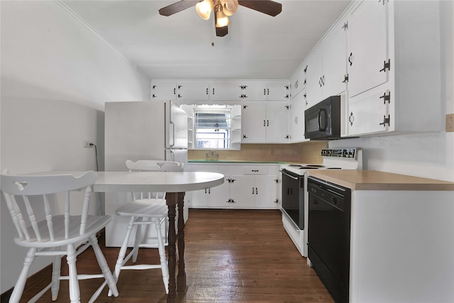 kitchen featuring dark wood-type flooring, ceiling fan, black appliances, and white cabinetry