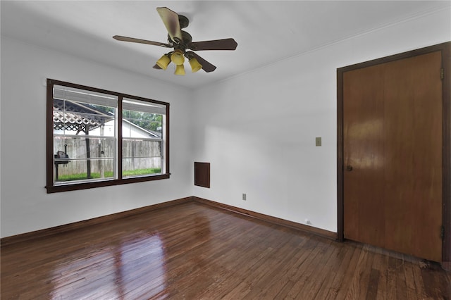 spare room with dark wood-type flooring and ceiling fan