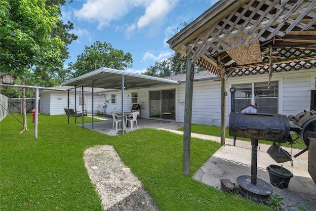 back of property with a patio area and a yard