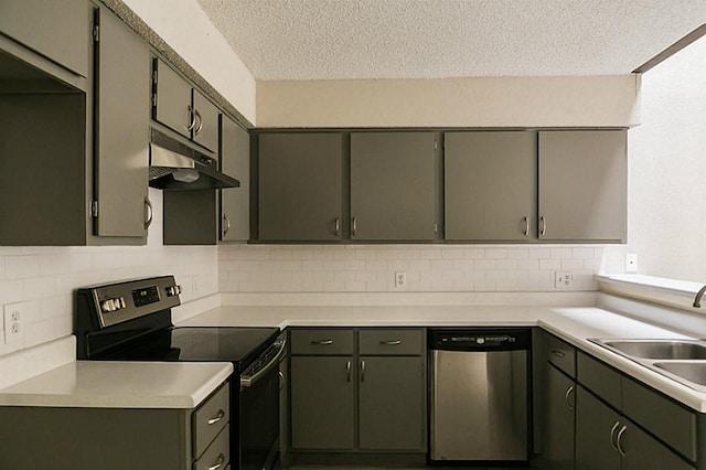 kitchen featuring sink, appliances with stainless steel finishes, a textured ceiling, and tasteful backsplash