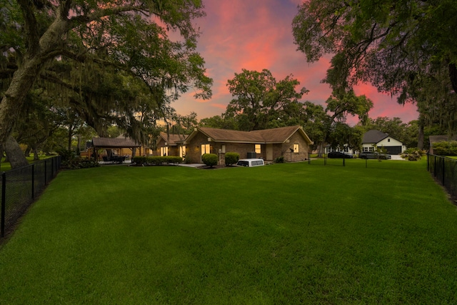 view of yard at dusk