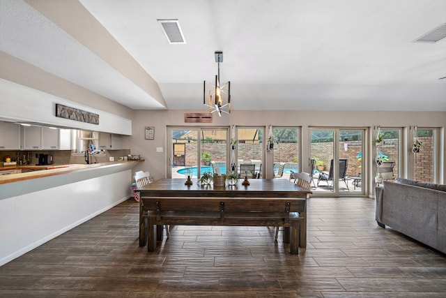 dining room featuring dark hardwood / wood-style flooring, an inviting chandelier, and french doors