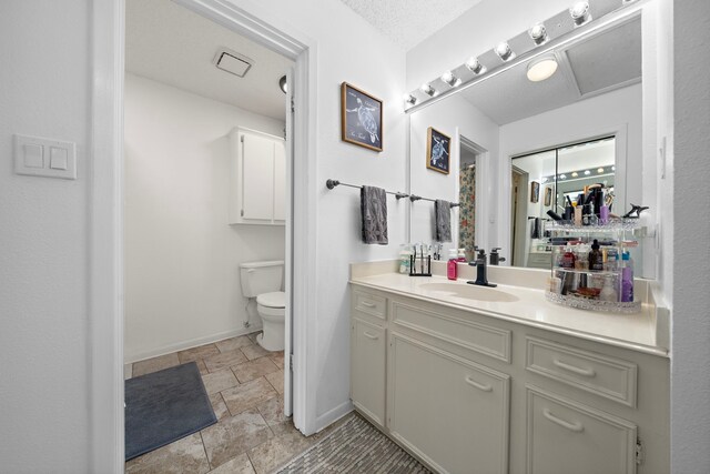 bathroom with vanity, tile patterned flooring, and toilet